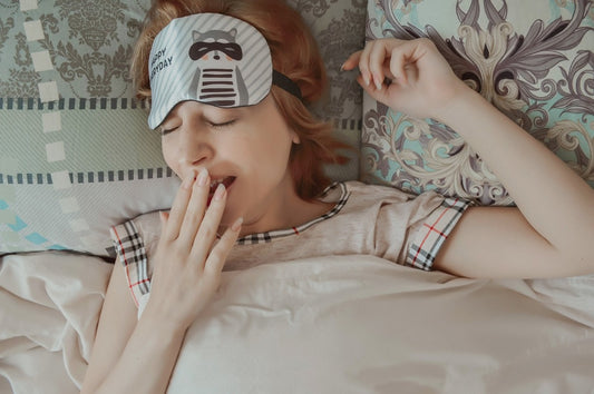 A woman trying to sleep on a bed