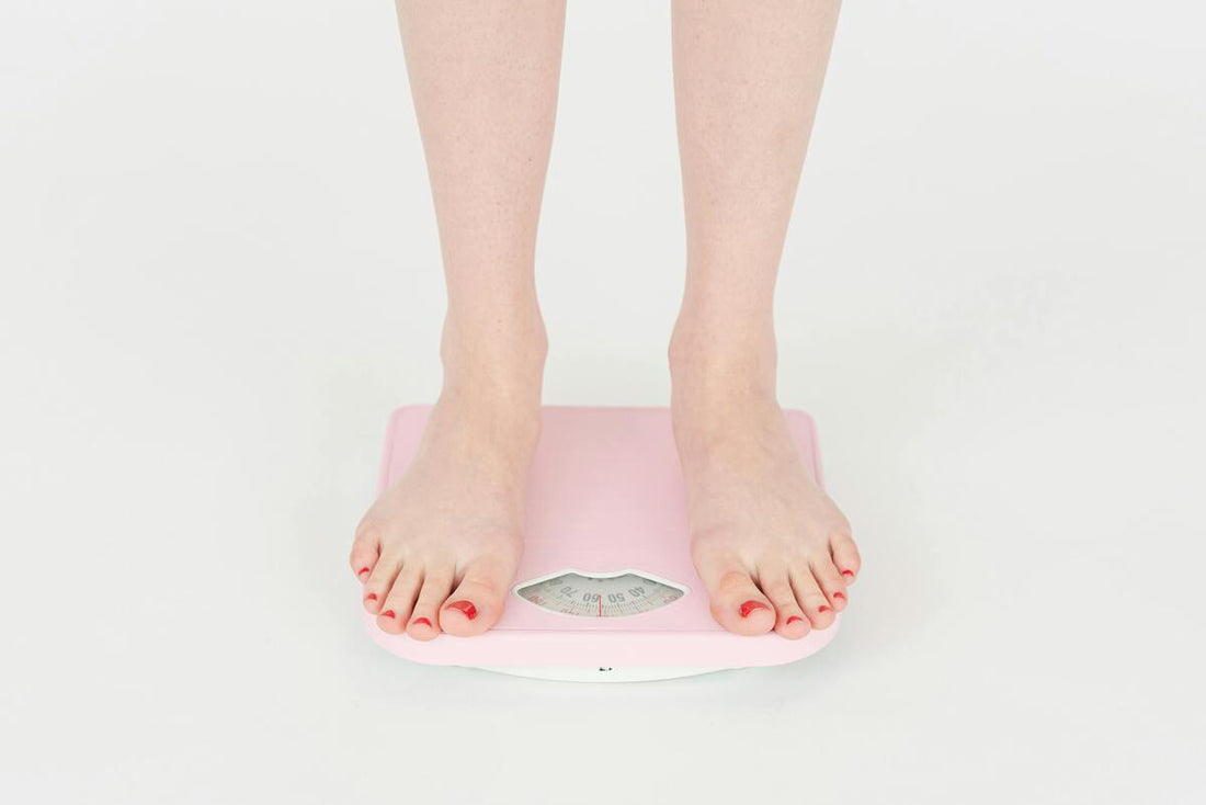 A person using a weighing scale